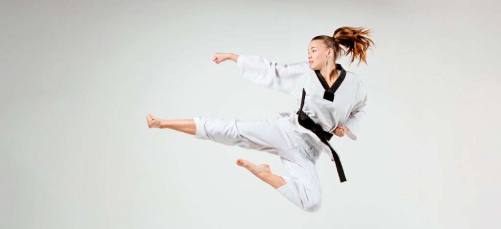 martial arts student performing a kick, or jump - pursueit